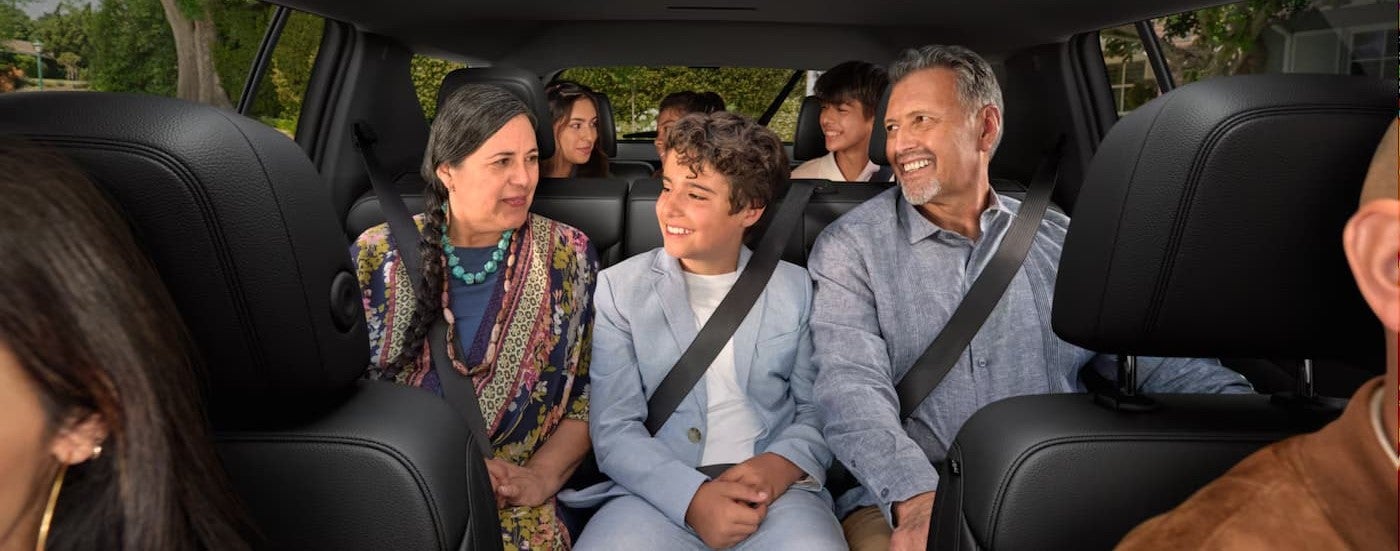 A group of people riding in a 2027 Chevy Traverse.