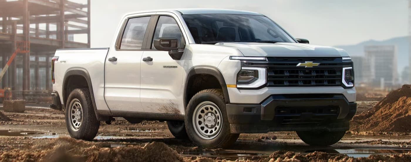 A white 2026 Chevy Silverado 1500 parked on a job site.