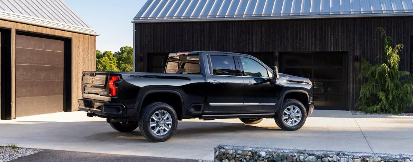 A black 2026 Chevy Silverado 2500 parked on a driveway.