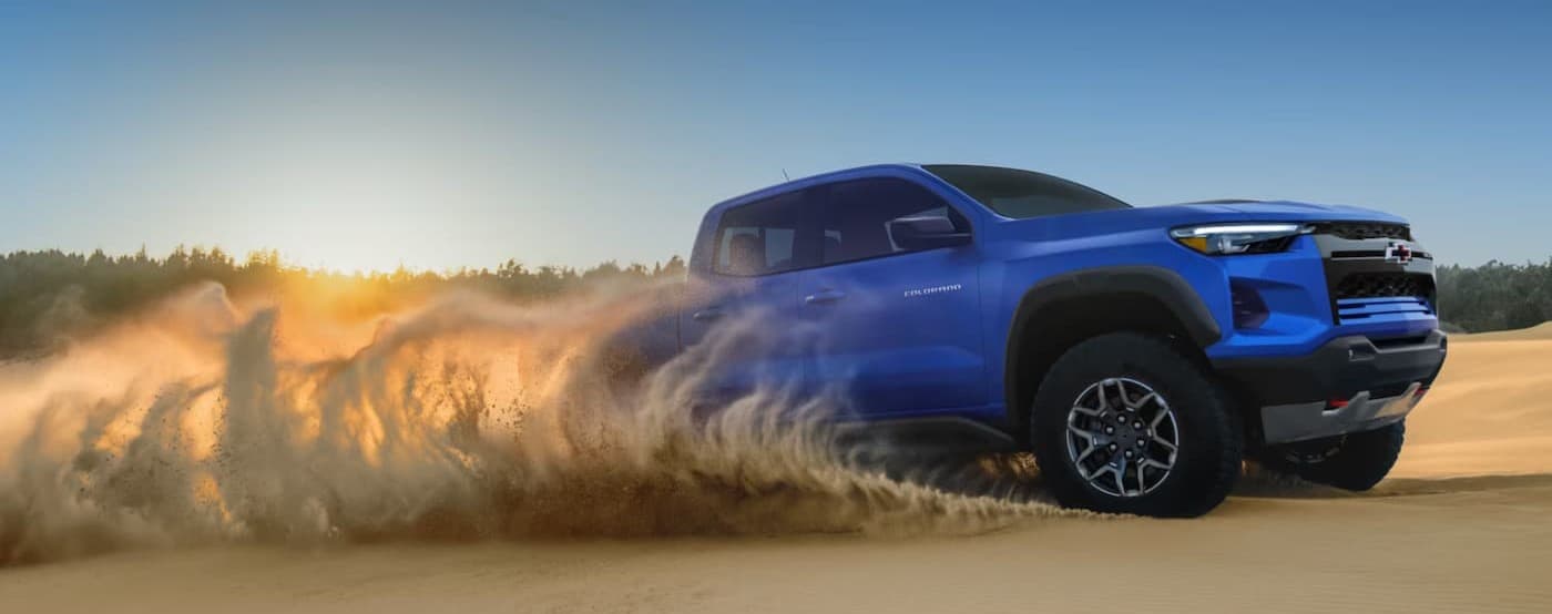 A blue 2026 Chevy Colorado driving offroad.