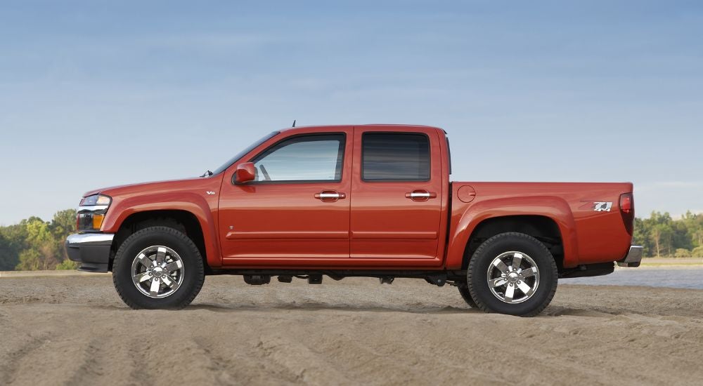 Orange 2009 Chevy Colorado Z71 parked on dirt.