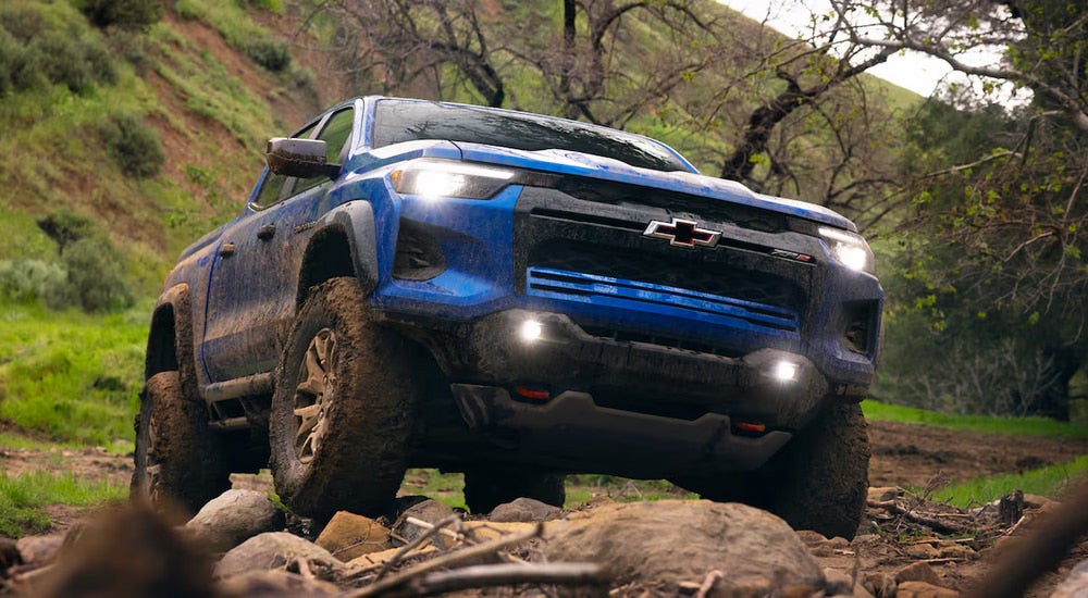 Blue 2026 Chevy Colorado off-roading on a rocky trail