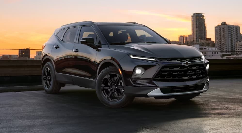 A black 2025 Chevy Blazer parked near a city.