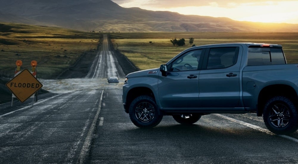 A grey 2022 Chevy Silverado 1500 Z71 TrailBoss near a flooded road.
