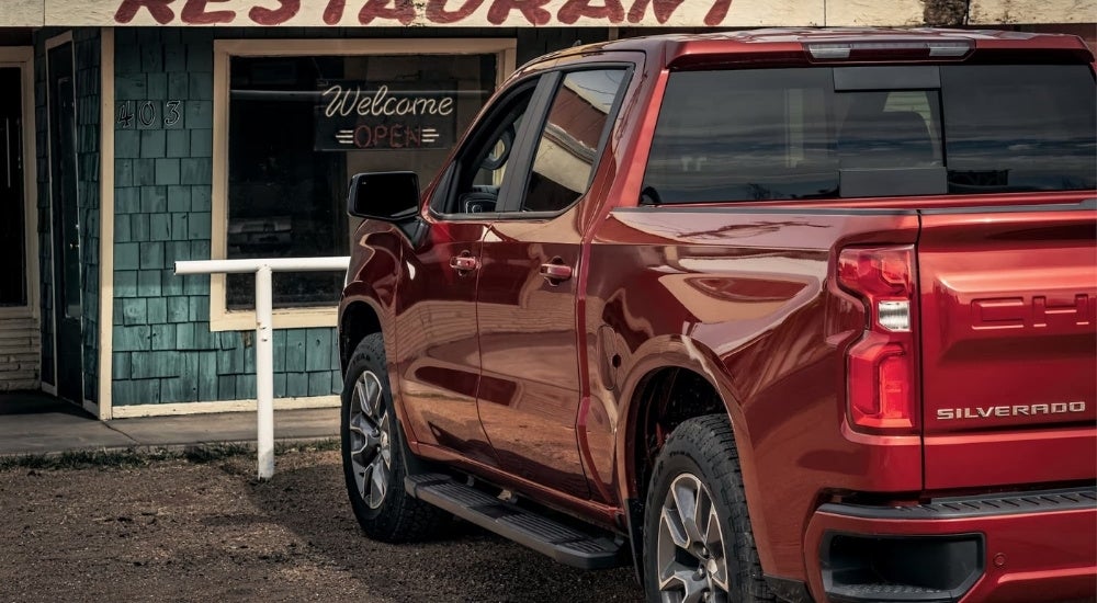 A red 2023 Chevy Silverado 1500 RST parked at a diner.