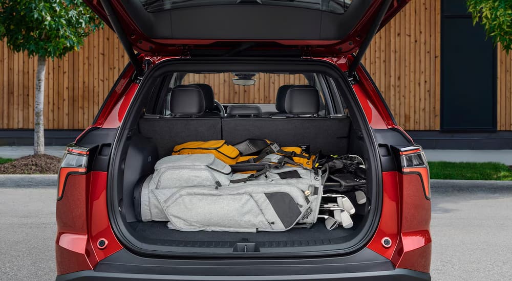 Golf gear in the back of a red 2026 Chevy Equinox RS
