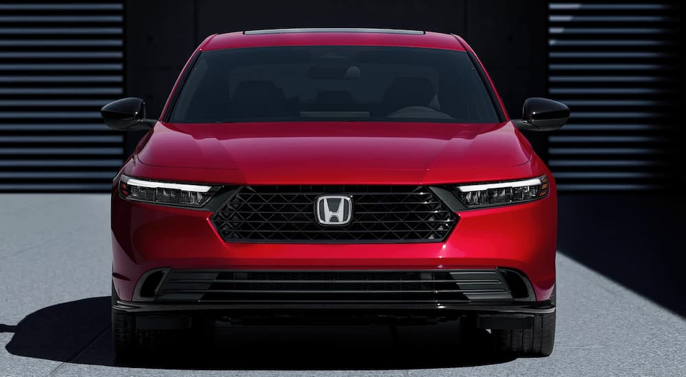 Red 2023 Honda Accord parked in front of a garage.