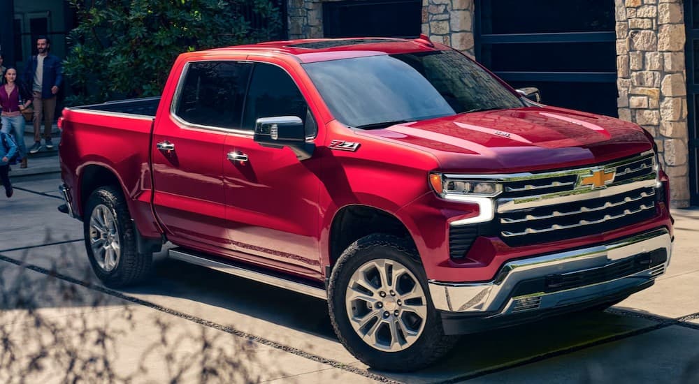 A red 2025 Chevy Silverado 1500 Z71 parked on a driveway.