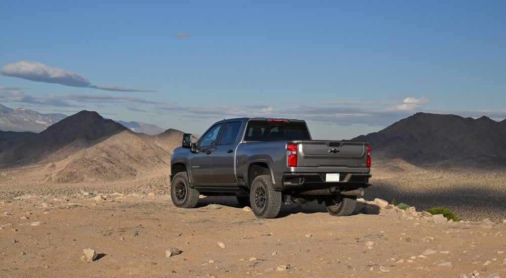 A grey 2024 Chevy Silverado 2500 HD ZR2 overlooking distant mountains.