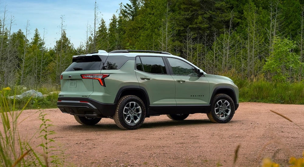 Rear of a green 2026 Chevy Equinox parked off-road.
