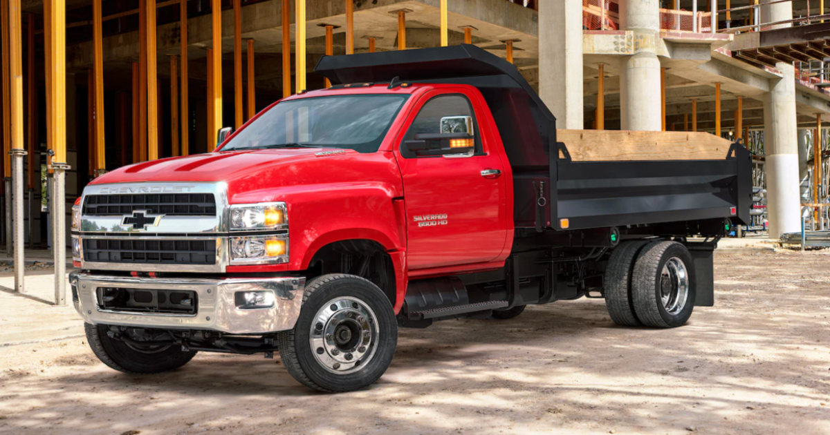 A red 2026 Chevy 6500 at a job site