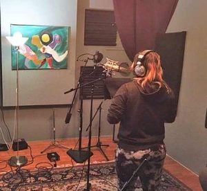 A Children's Home resident singing at Songbuilder Studio