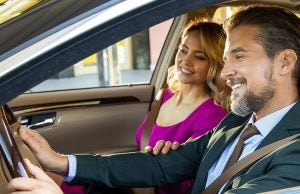 Happy man &amp; woman in the car