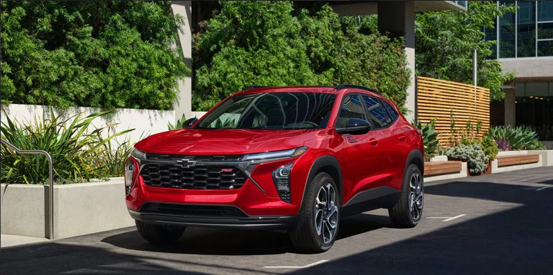 A red Chevy Trax parked on the side of the road.