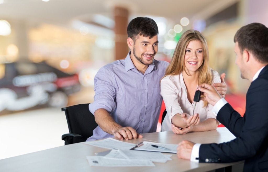 Couple receiving car keys