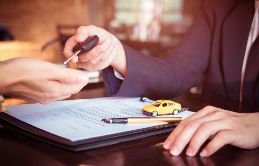 Person handing over a car key