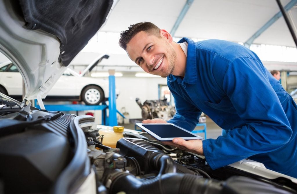 Service tech working on an engine