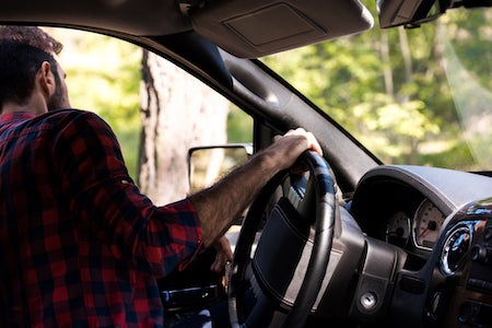 Person behind the wheel of a car