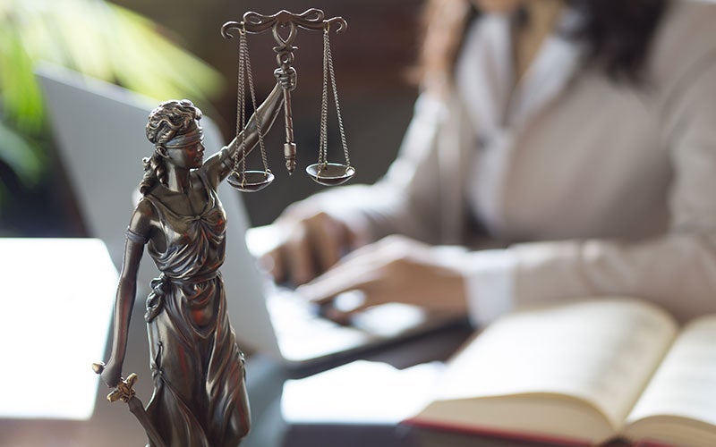 liberty scales with woman attorney in the background