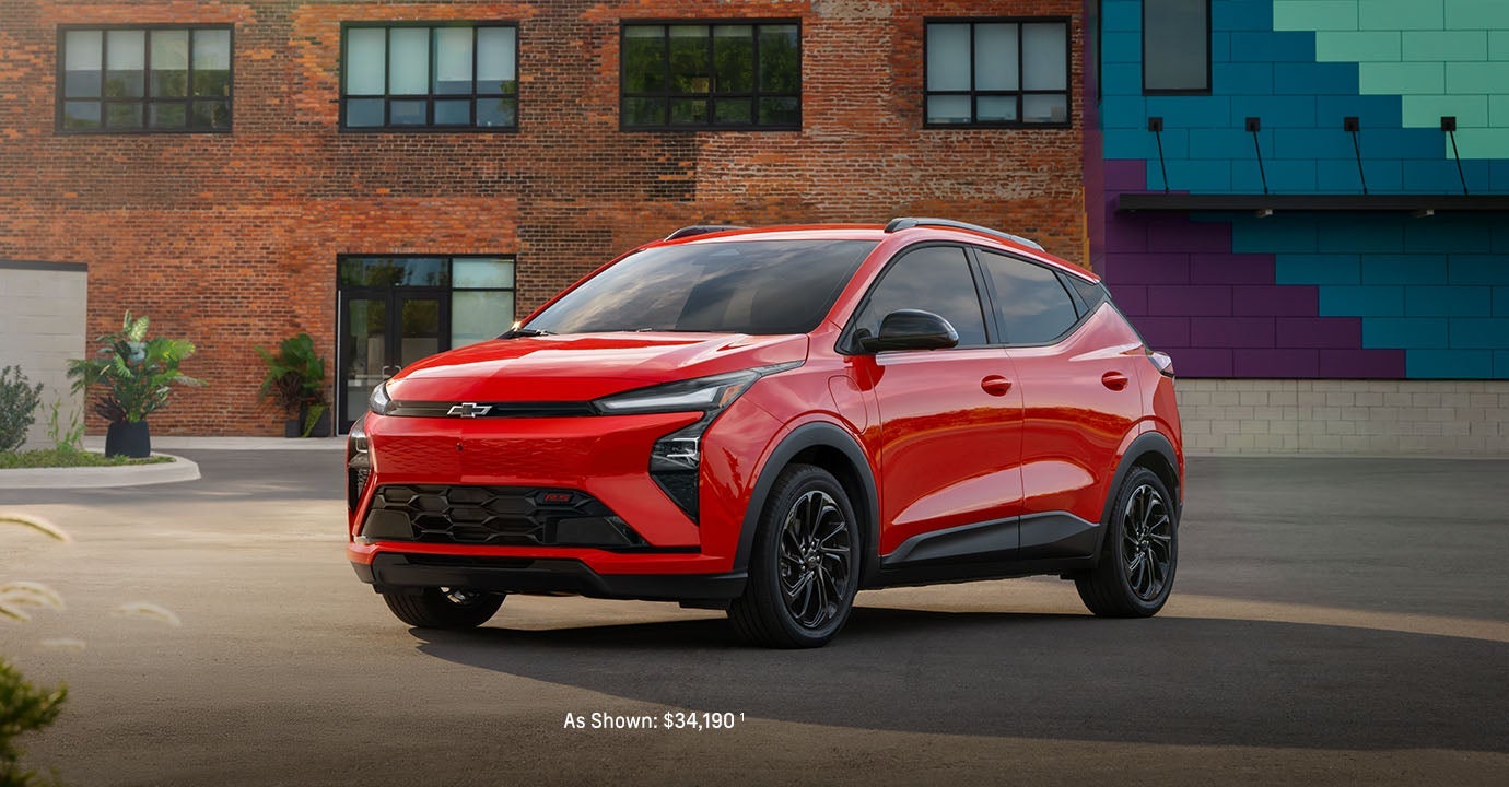 2027 Bolt EV parked in front of a brick building