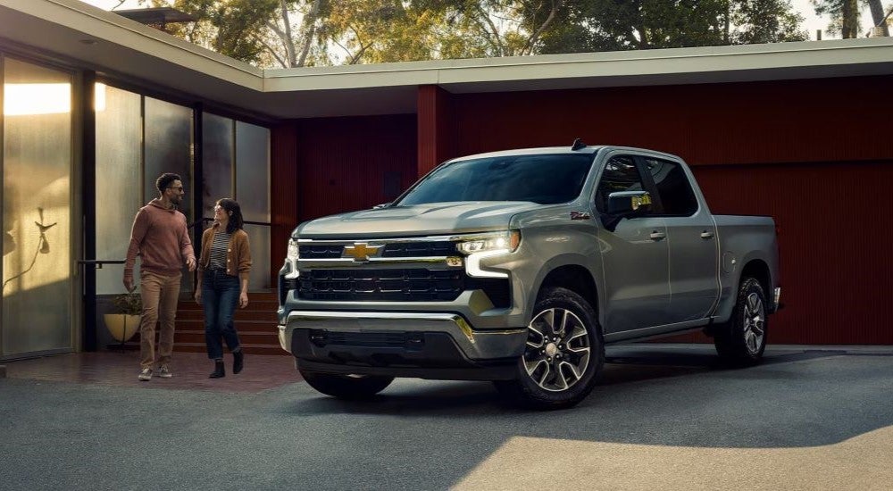 A silver 2024 Chevy Silverado 1500 Z71 for sale is shown parked in a driveway.