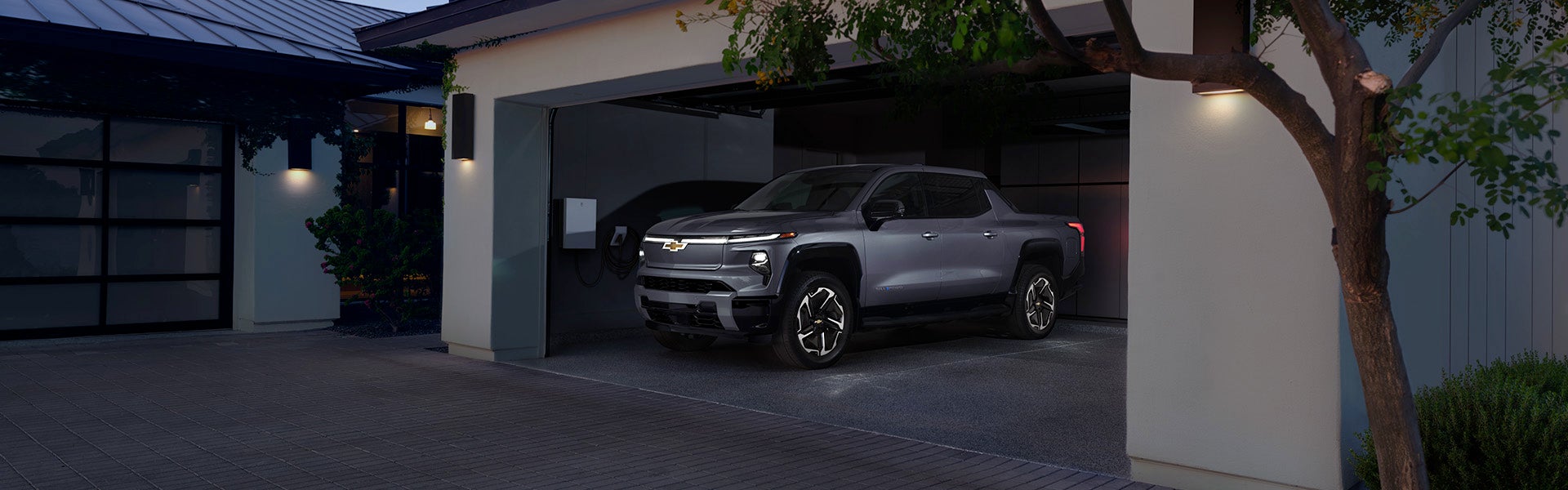 A 2026 Chevrolet Silverado EV parked in a modern garage with soft lighting.