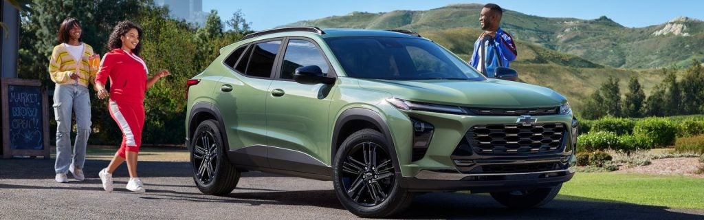 Green 2025 Chevy Trax with several people about to get inside