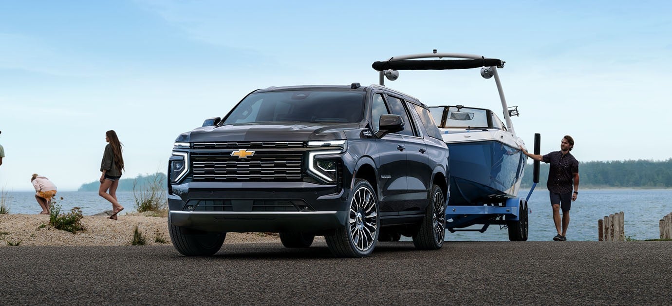 2026 Chevrolet Suburban demonstrating powerful towing performance at a waterfront boat ramp