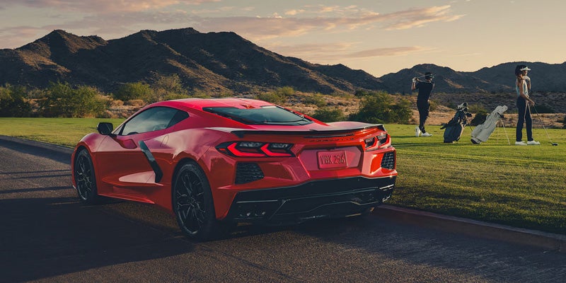 A 2026 red Corvette parked along the roadside, highlighting its sporty appearance and modern features.