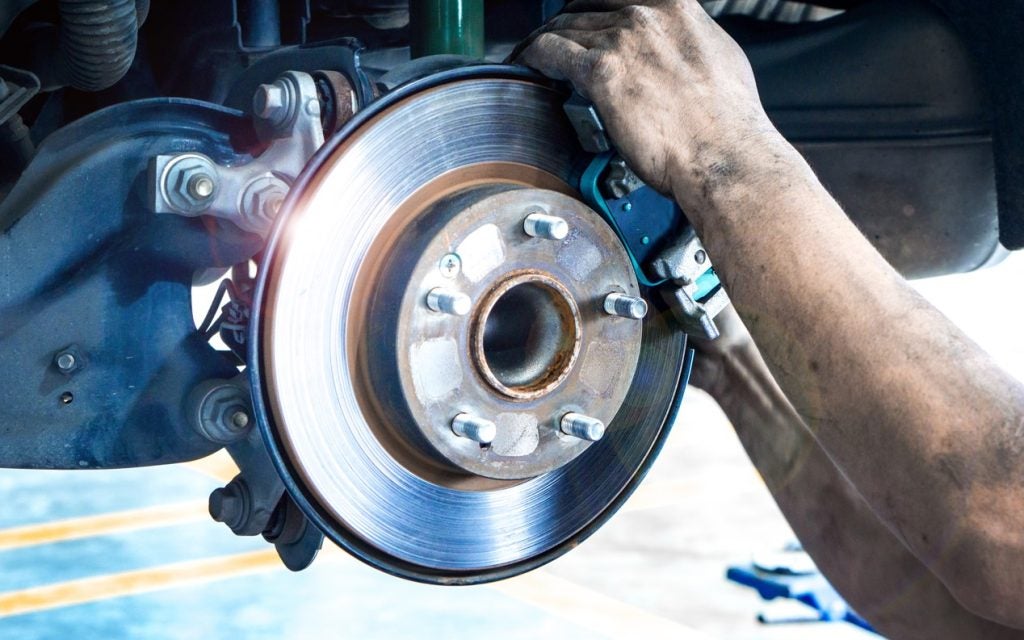 Mechanic working on wheel alignment