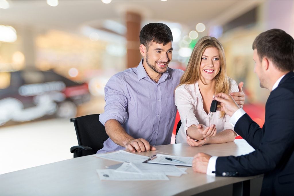 Couple receiving new car keys