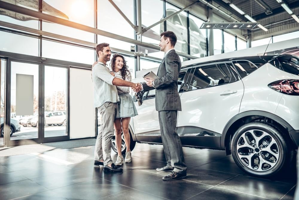 Couple at car dealership