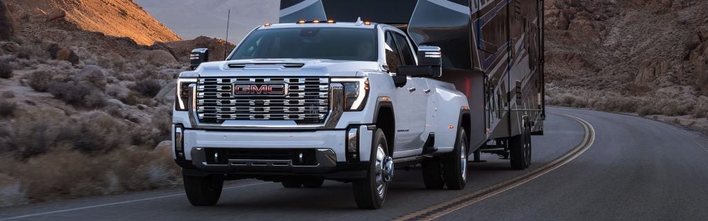 2025 Sierra HD pulling a heavy load up a mountain pass