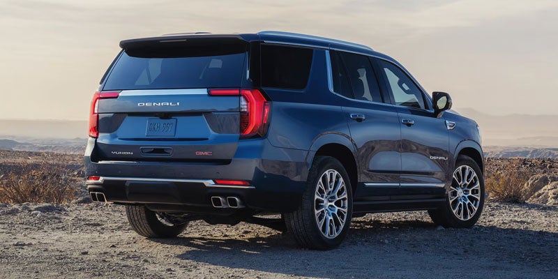Rear view of a 22026 GMC Yukon Denali, highlighting its design and features, showcased in Golden, CO.