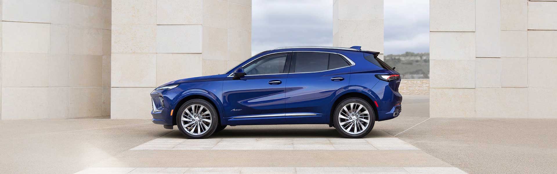 2025 Buick Envision blue compact luxury SUV shown in side profile, featuring refined modern design.