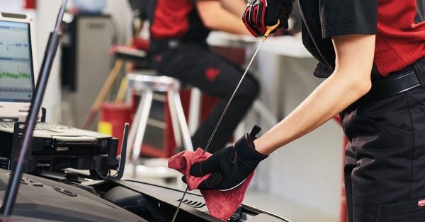 Toyota service technician working on an oil change