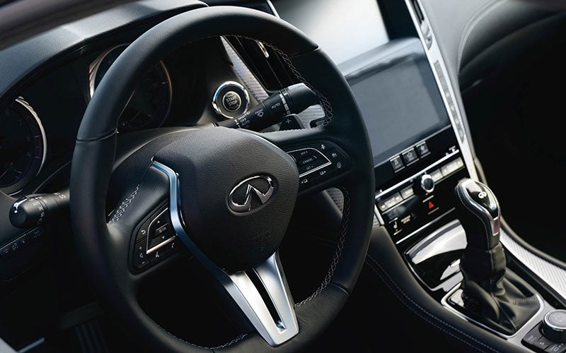 Interior view of an Infiniti car dashboard and steering wheel