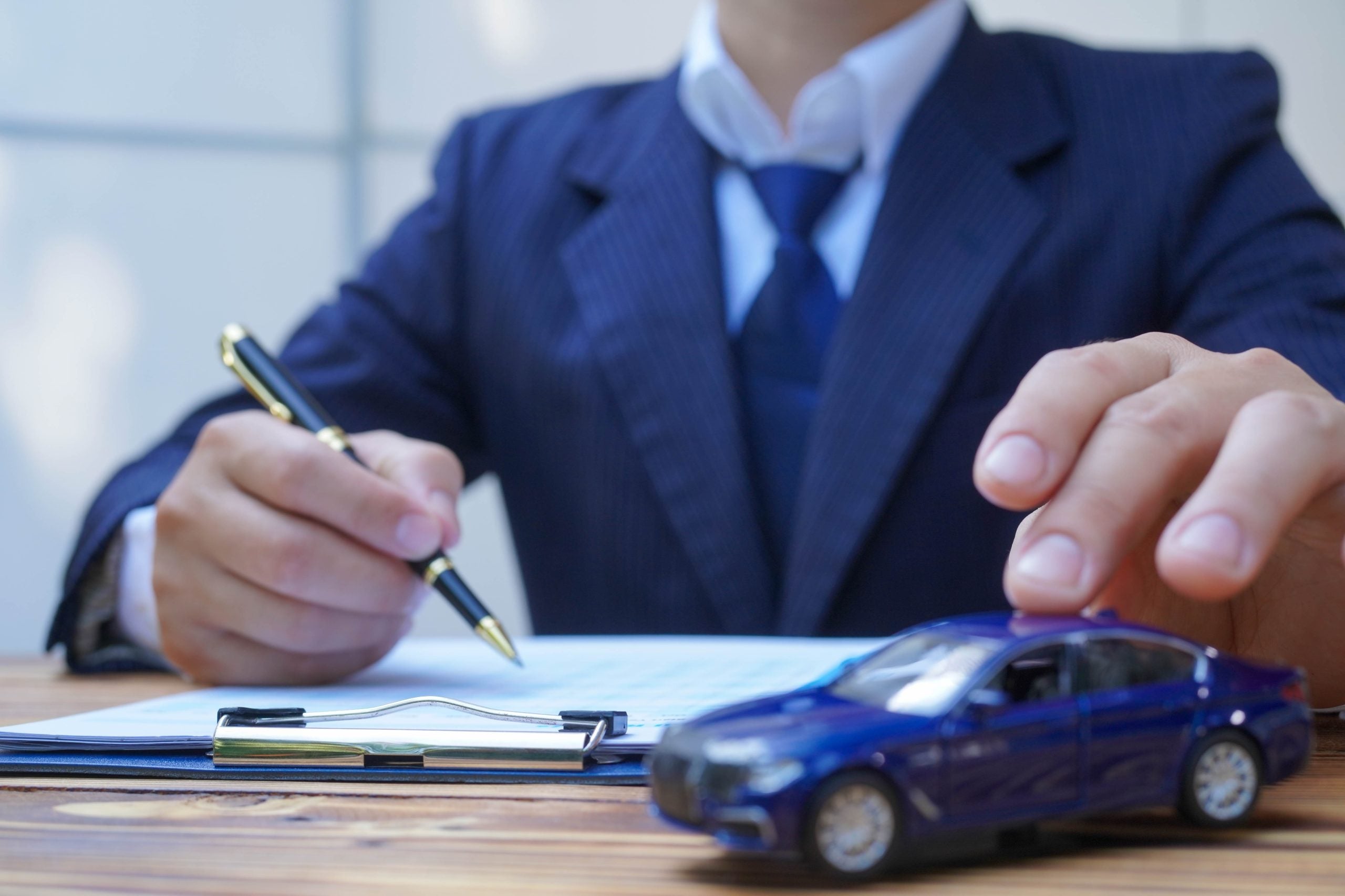 Businessperson signing car finance documents