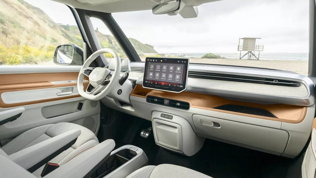 Interior view of a car featuring a steering wheel and a tablet mounted on the dashboard.