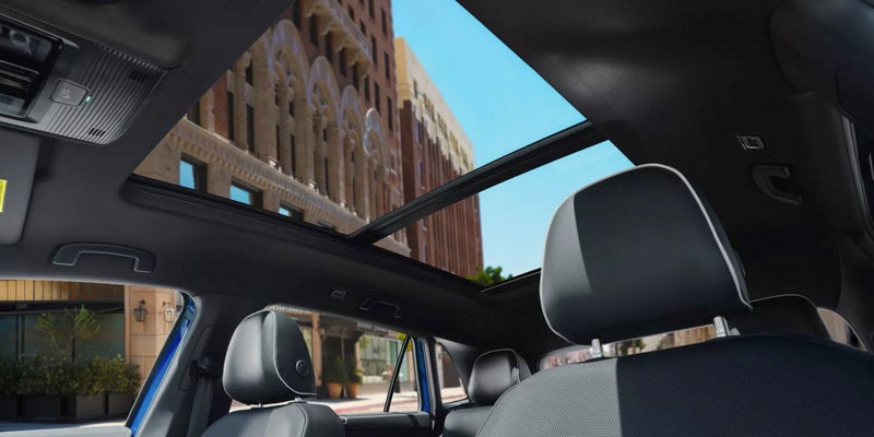 Sunroof view in a 2024 Volkswagen Atlas Cross Sport, showcasing the open glass panel and interior details.