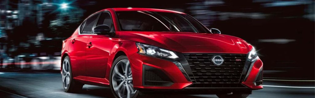 2026 Nissan Altima riding in the city at mid-night.