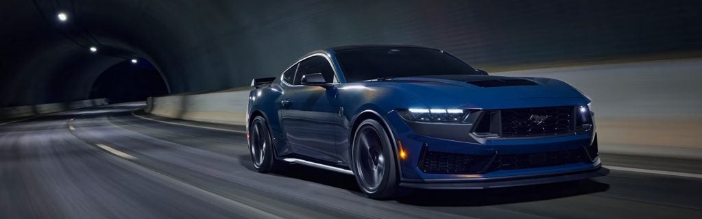 A blue 2026 Ford Mustang drives in a tunnel near Winchester, MA. 