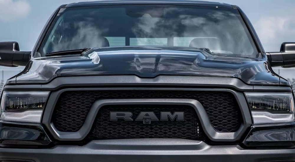 The close-up of a grille on a black 2024 Ram 1500 is shown.