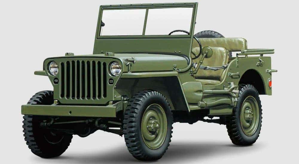 An olive green 1942 Jeep Willys MB is angled left shown against a white background.