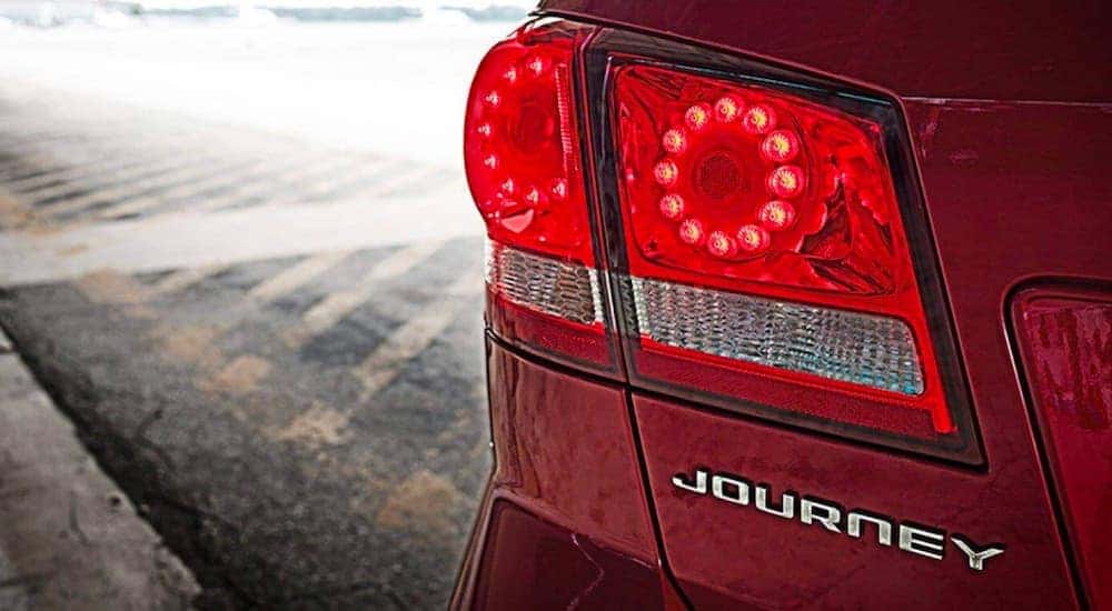 A close up shows the driver side taillight on a red 2020 Dodge Journey.