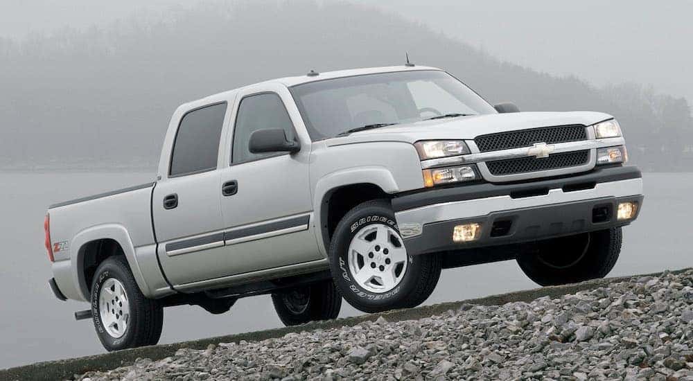 A silver 2004 Chevy Silverado 1500 is shown from the side parked on a misty road.