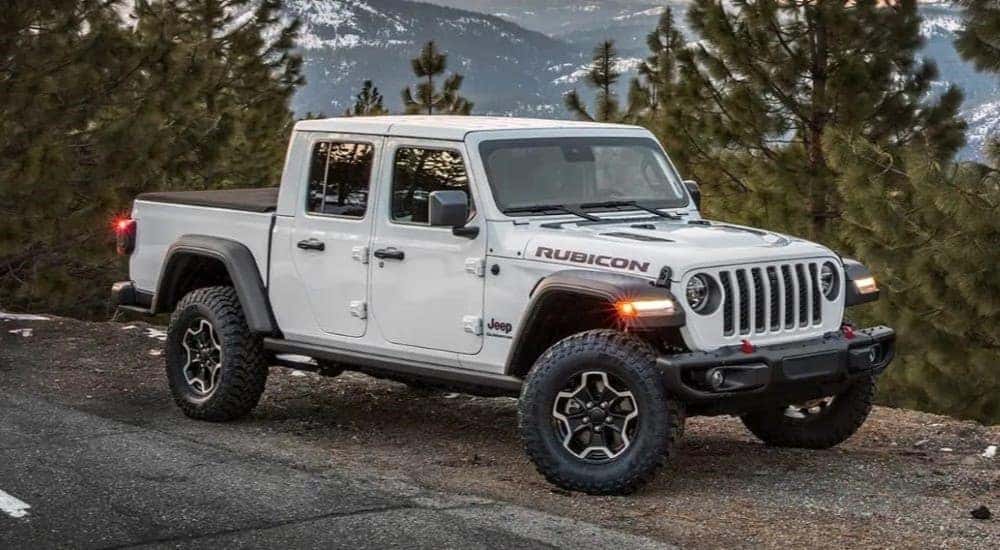 A white 2023 Jeep Gladiator Rubicon is shown parked on the side of a road.