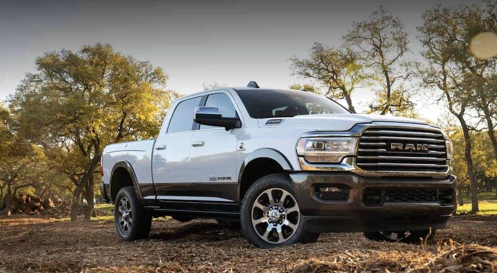 A white 2020 Ram 2500 is parked in front of trees after leaving a Ram dealer near me.