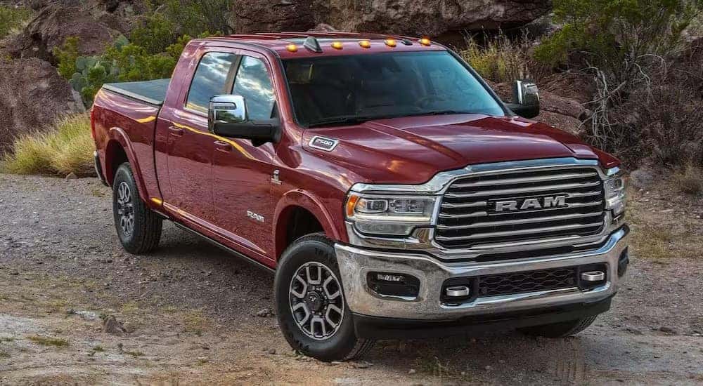 A red 2024 Ram 2500 is shown parked off-road.