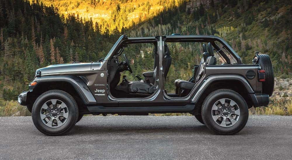 A grey 2022 Jeep Wrangler Sahara is shown from the side while parked.